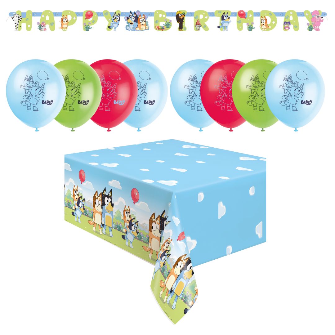 Birthday party decorations with balloons and table cover featuring cartoon characters.